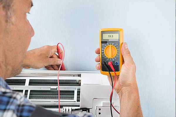 NATE certified HVAC technician servicing an AC unit in Bucks County PA